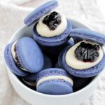 blueberry macarons in a bowl.