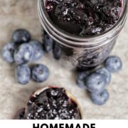 blueberry jam in jar with text overlay.