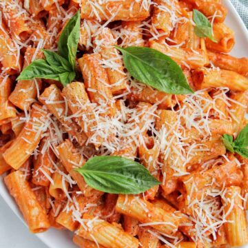 spicy vodka rigatoni pasta topped with parmesan cheese and basil.