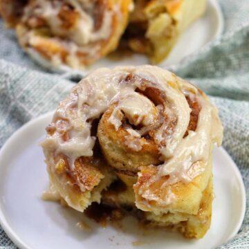 frosted cinnamon roll on a plate.