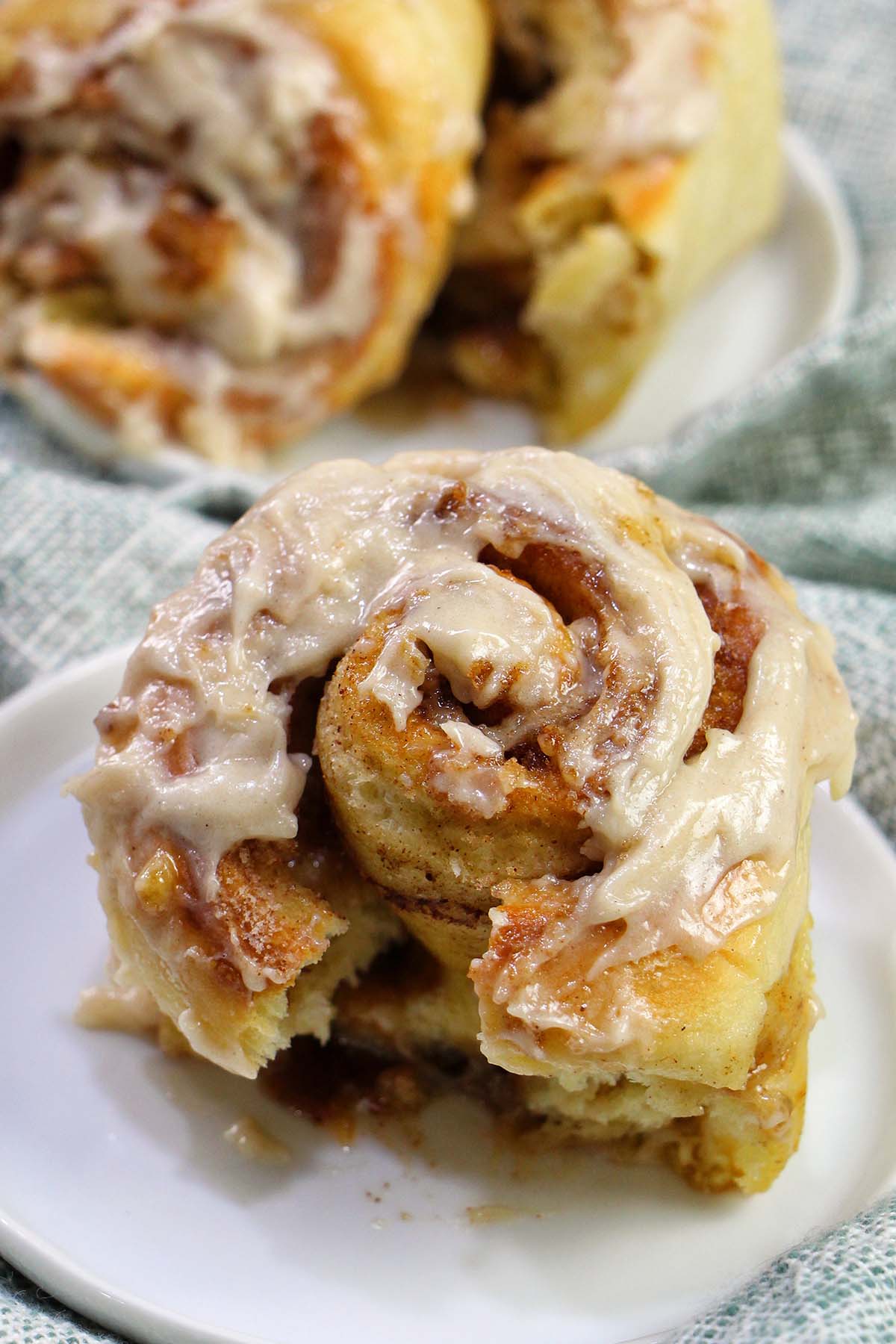frosted cinnamon roll on a plate.