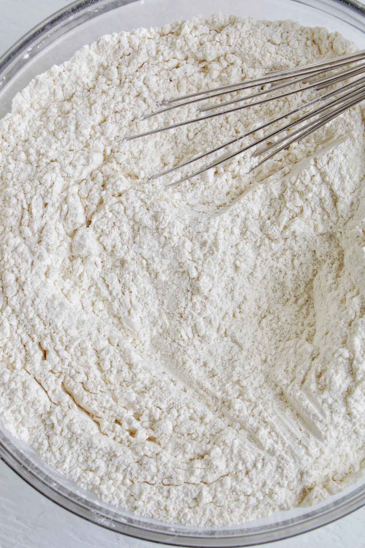 flour in a bowl with a whisk.