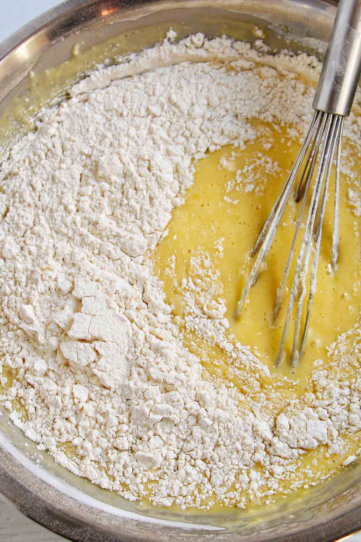 mixing flour into lemon cake batter.