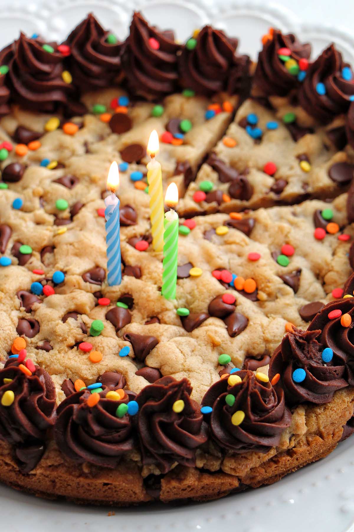 birthday candles in a cookie cake with chocolate frosting.