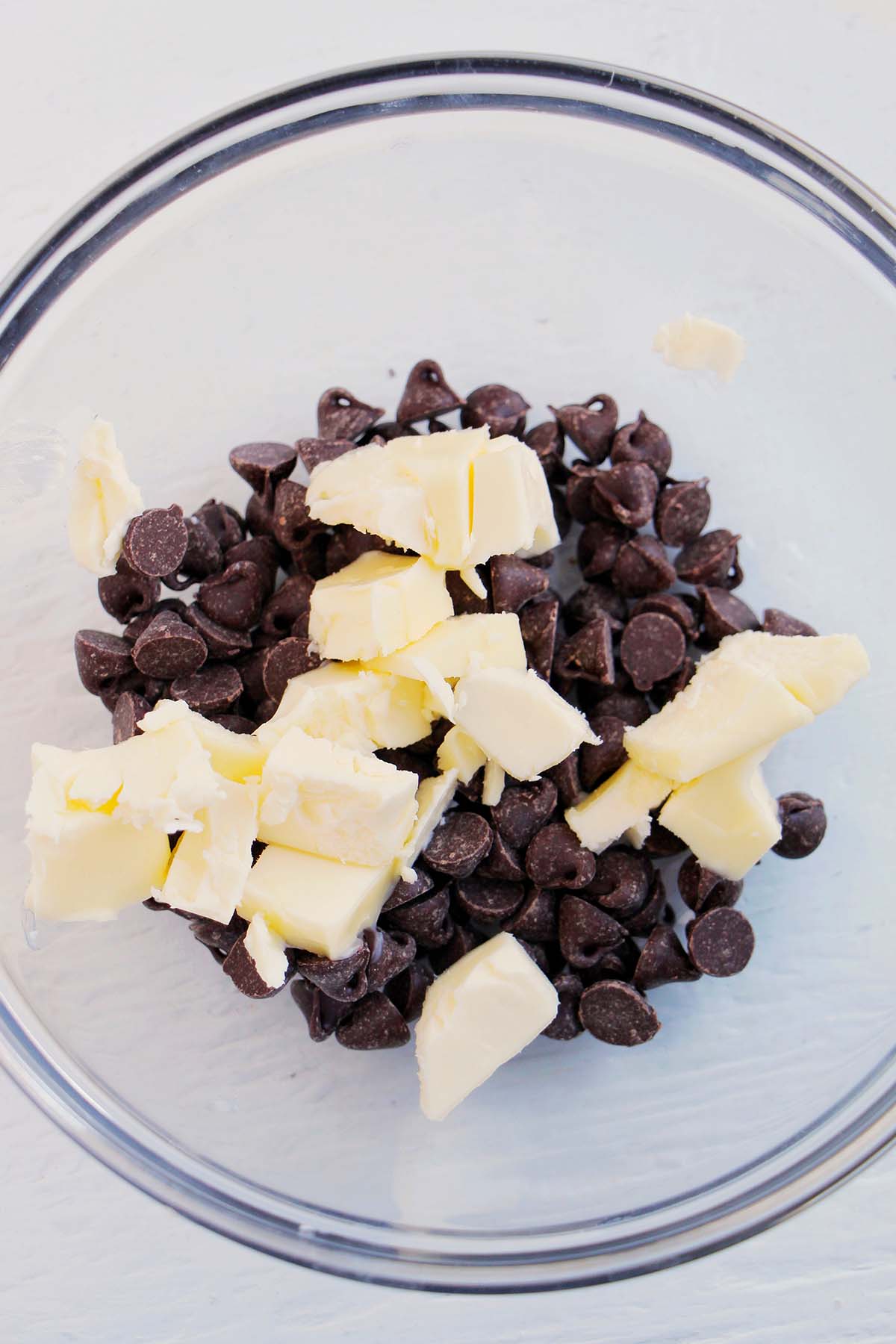 mixing bowl filled with butter and semi-sweet chocolate.