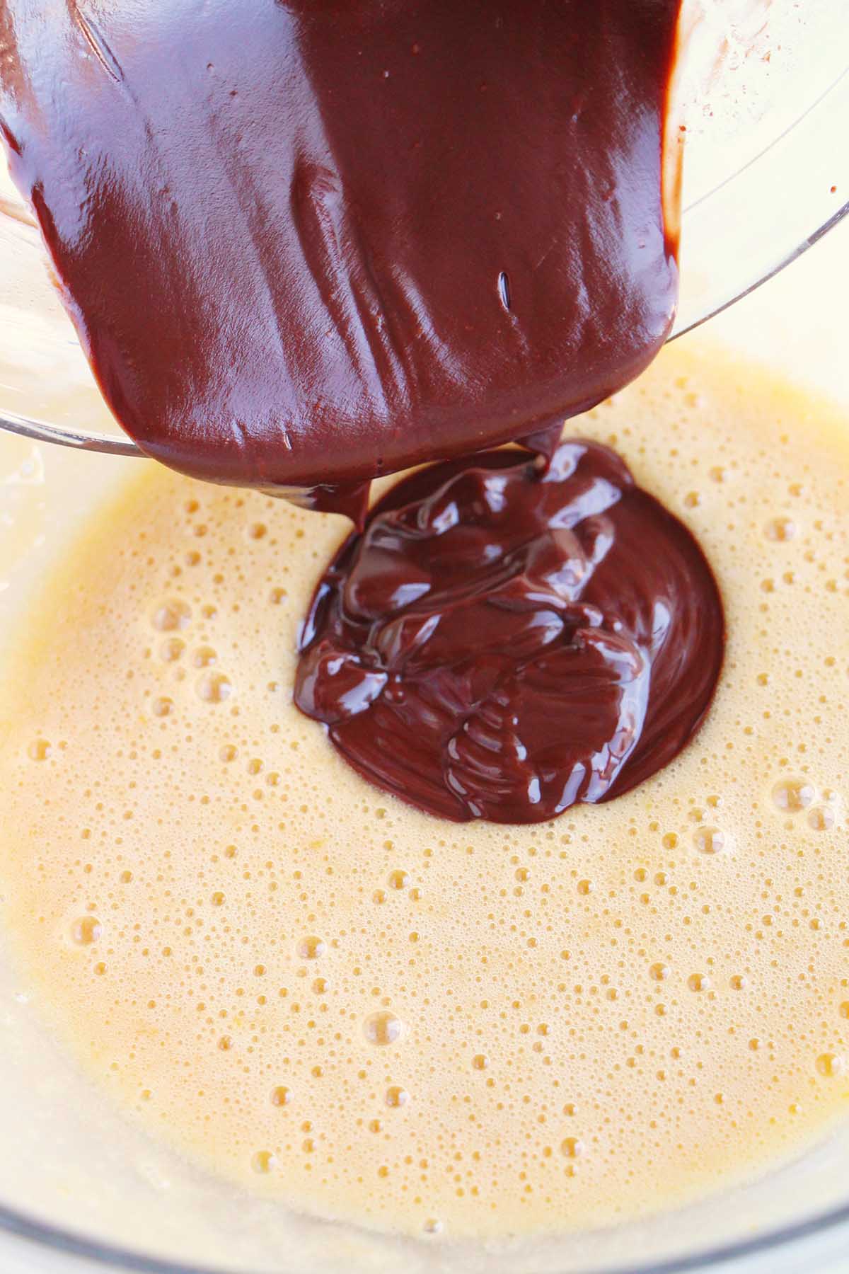 pouring chocolate into egg mixture.