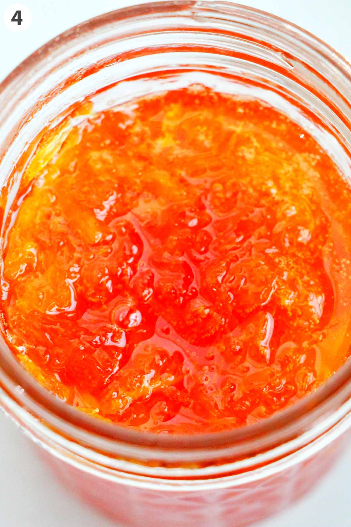 numbered photo with orange jam in a jar.