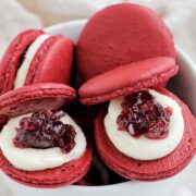 cranberry macarons in a bowl.