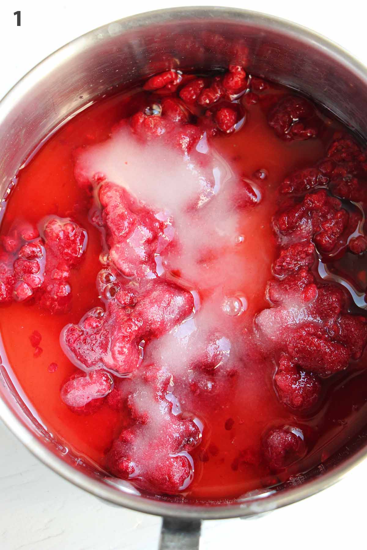 numbered photo with raspberries and sugar in a pot.