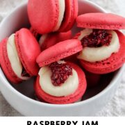 raspberry jam macarons in a bowl with text overlay.