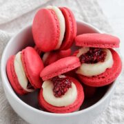 raspberry jam macarons in a bowl.