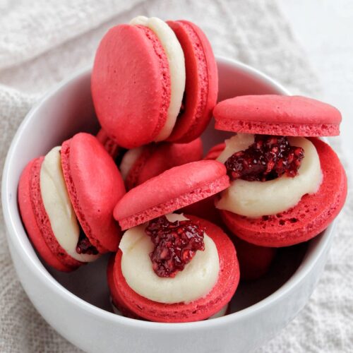 raspberry jam macarons in a bowl.