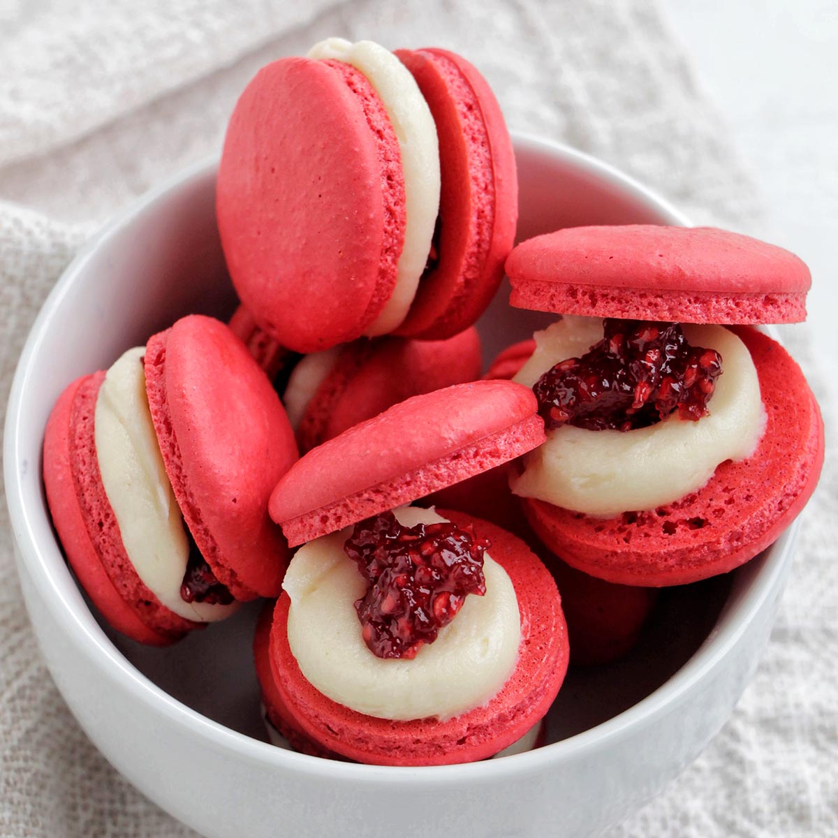 raspberry jam macarons in a bowl.