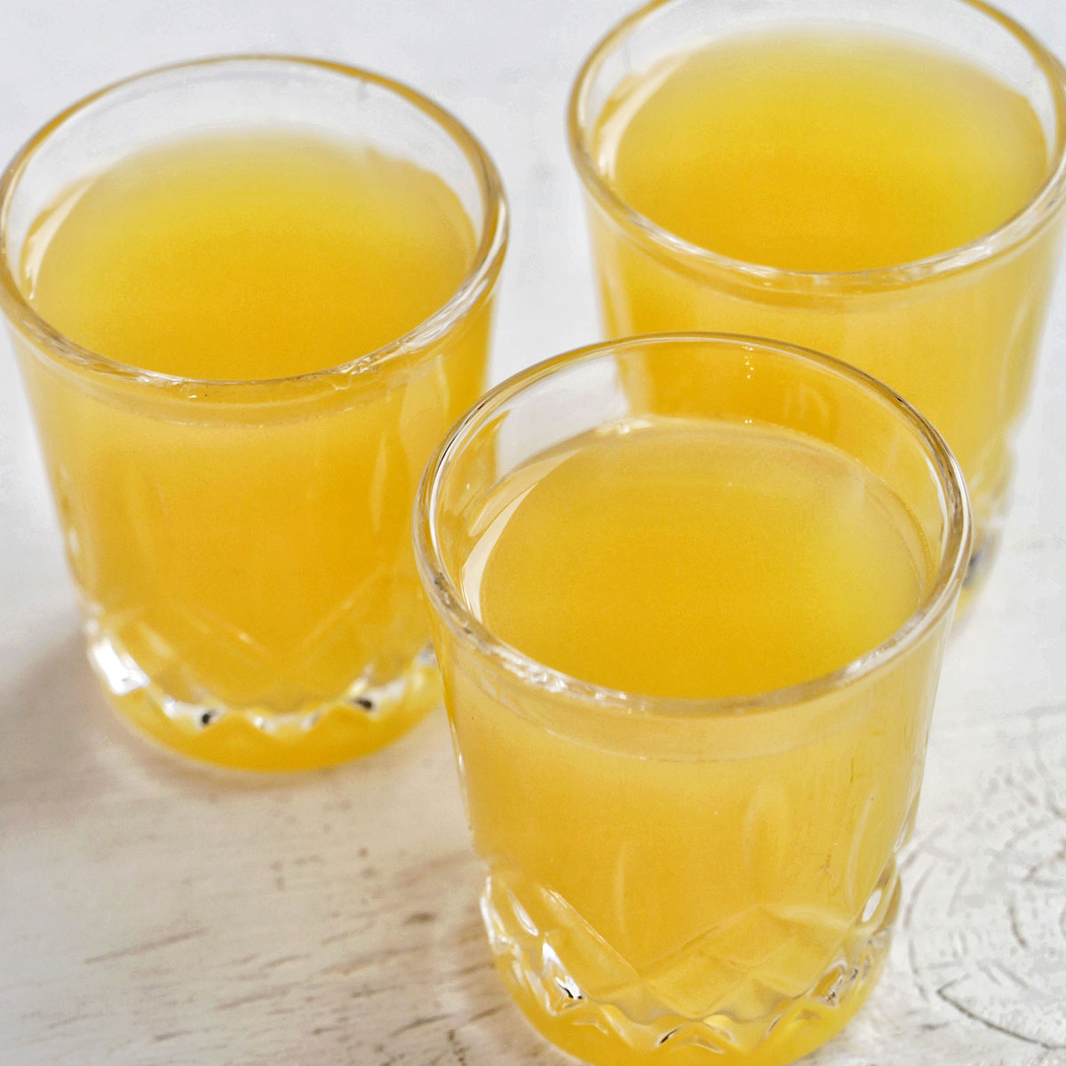 three orange colored Thanksgiving shots.