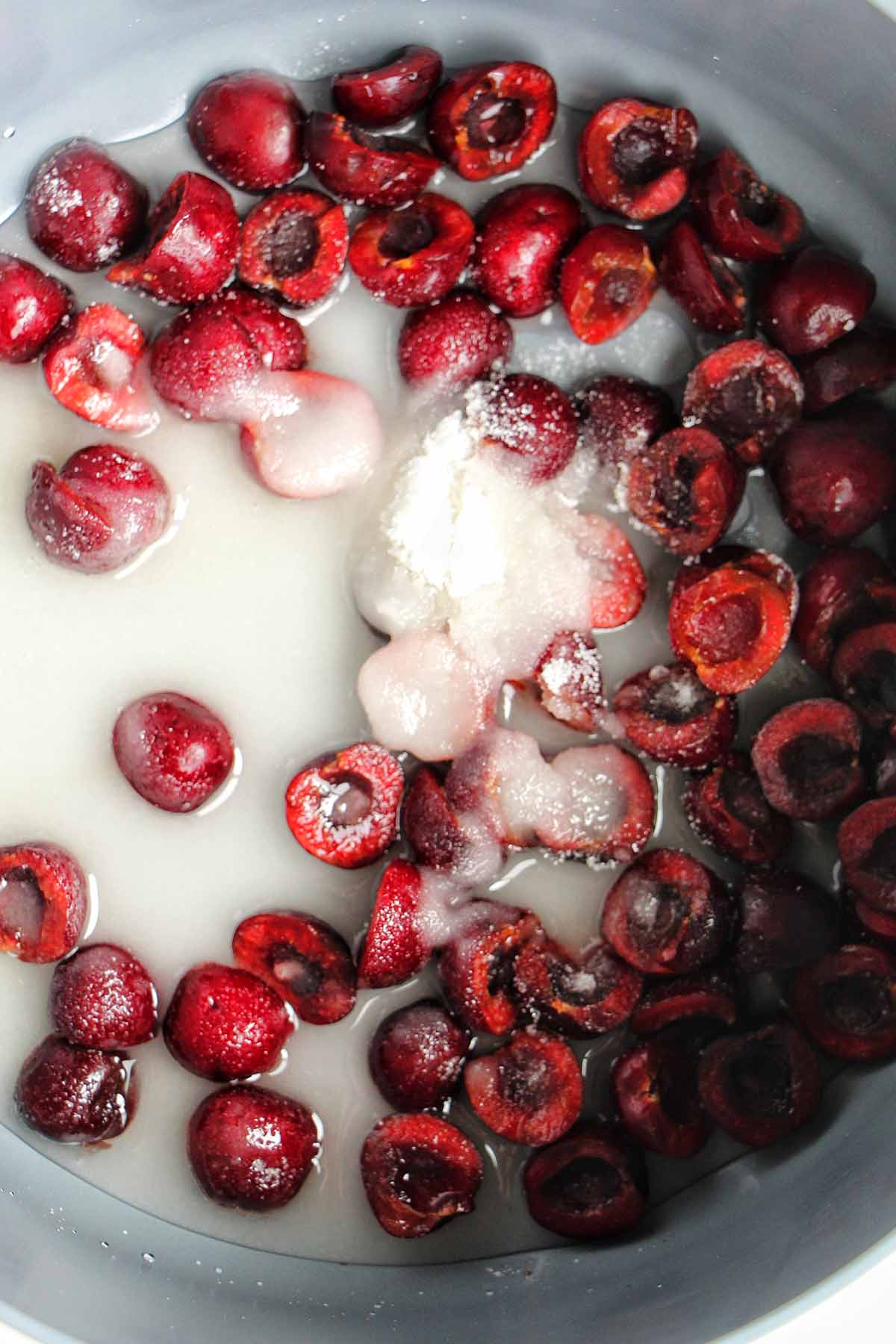 cherry jam ingredients in pots.