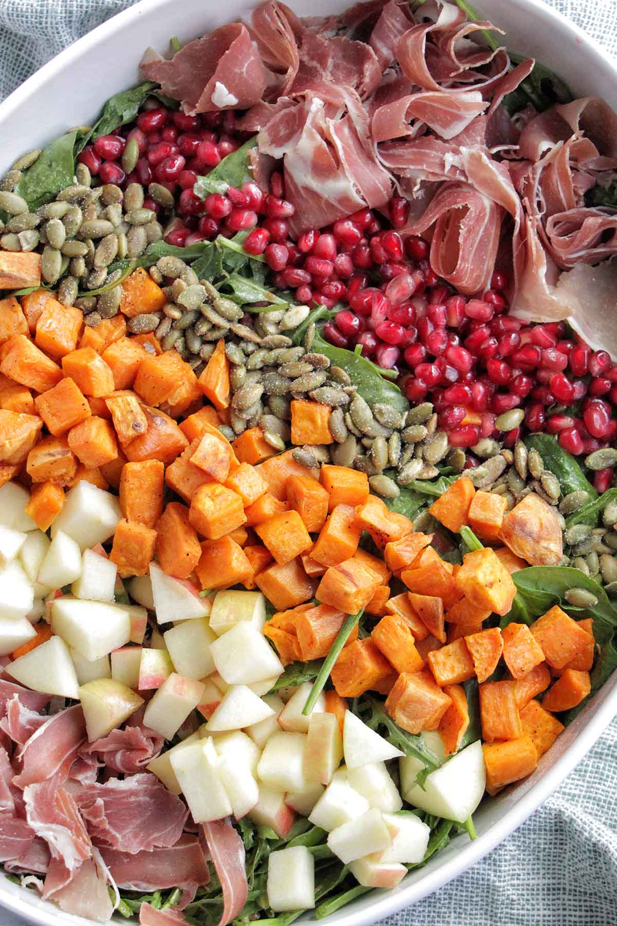 cobb salad layered with fall vegetables and toppings.