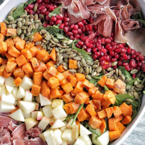 cobb salad layered with fall vegetables and toppings.