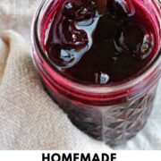 cherry jam in a jar with text overlay.