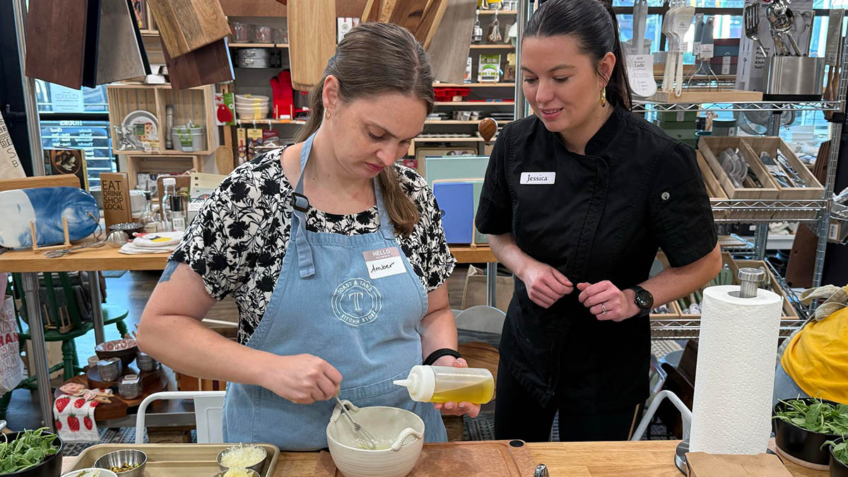 girl cooking next to a culinary instructor.