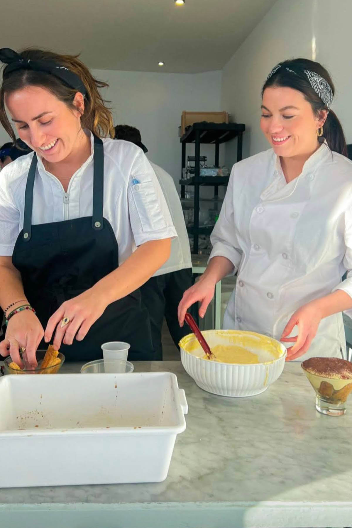 two girls making tiramisu.