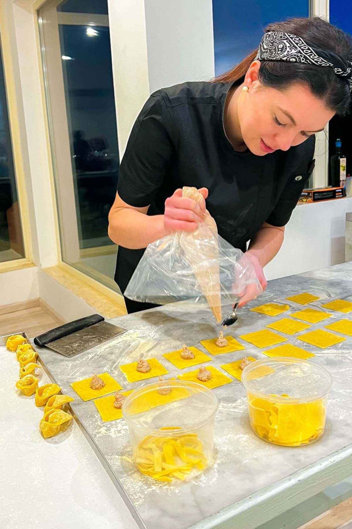 girl filling ravioli pasta.