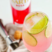 pink Sarti spritz in front of Sarti Rosa bottle.