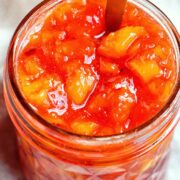 peach jam in a mason jar.