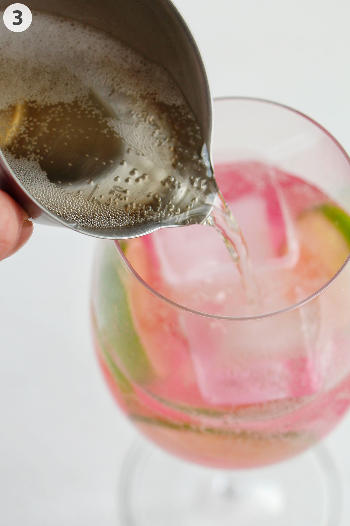 numbered photo pouring Prosecco into pink spritz.