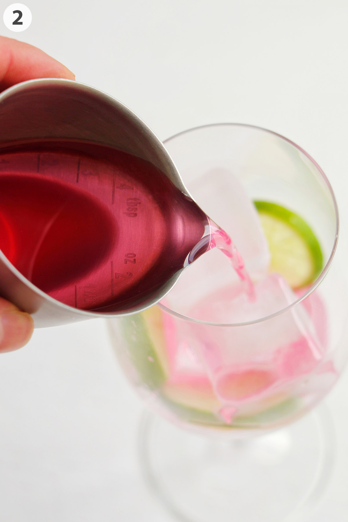 number photo pouring Sarti Rosa into wine glass.