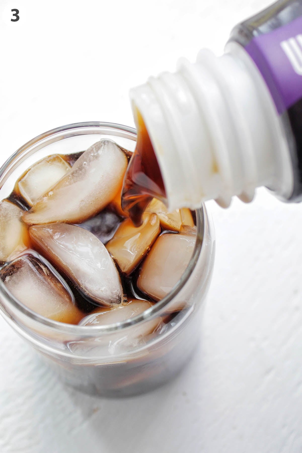 numbered photo showing cold brew pouring into glass of ice.